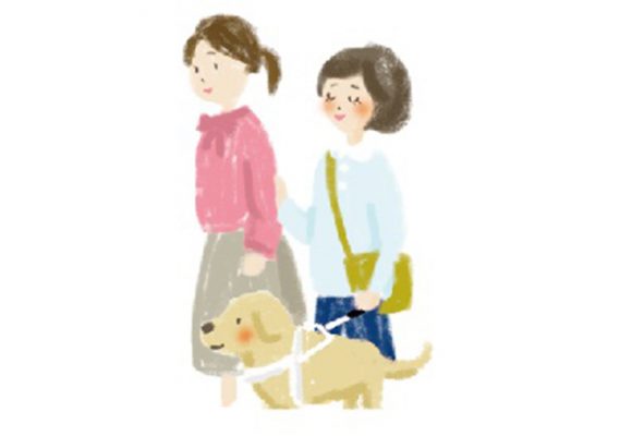 前に女性、後ろに盲導犬ユーザー。盲導犬ユーザーが女性の肘を持っている。
